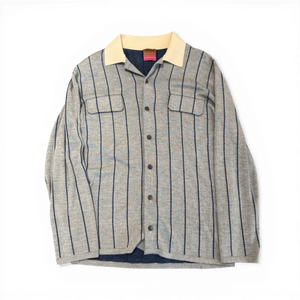 Ākaibu Store light grey cashmere shirt with navy vertical stripes and a cream collar. Features two chest pockets and button closure.